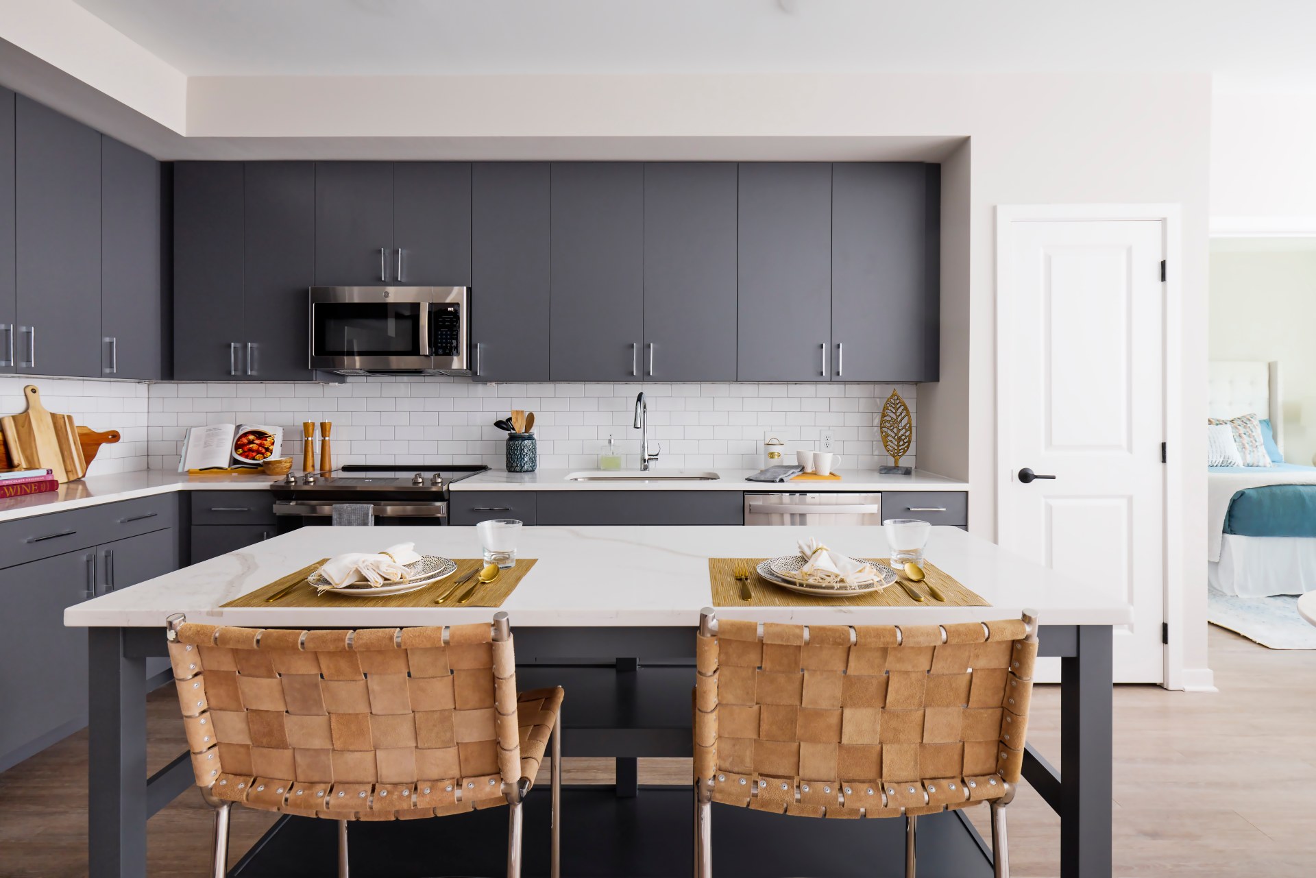 white granite counter tops & stainless steel appliances in kitchen apartment at Aster College Park, MD.